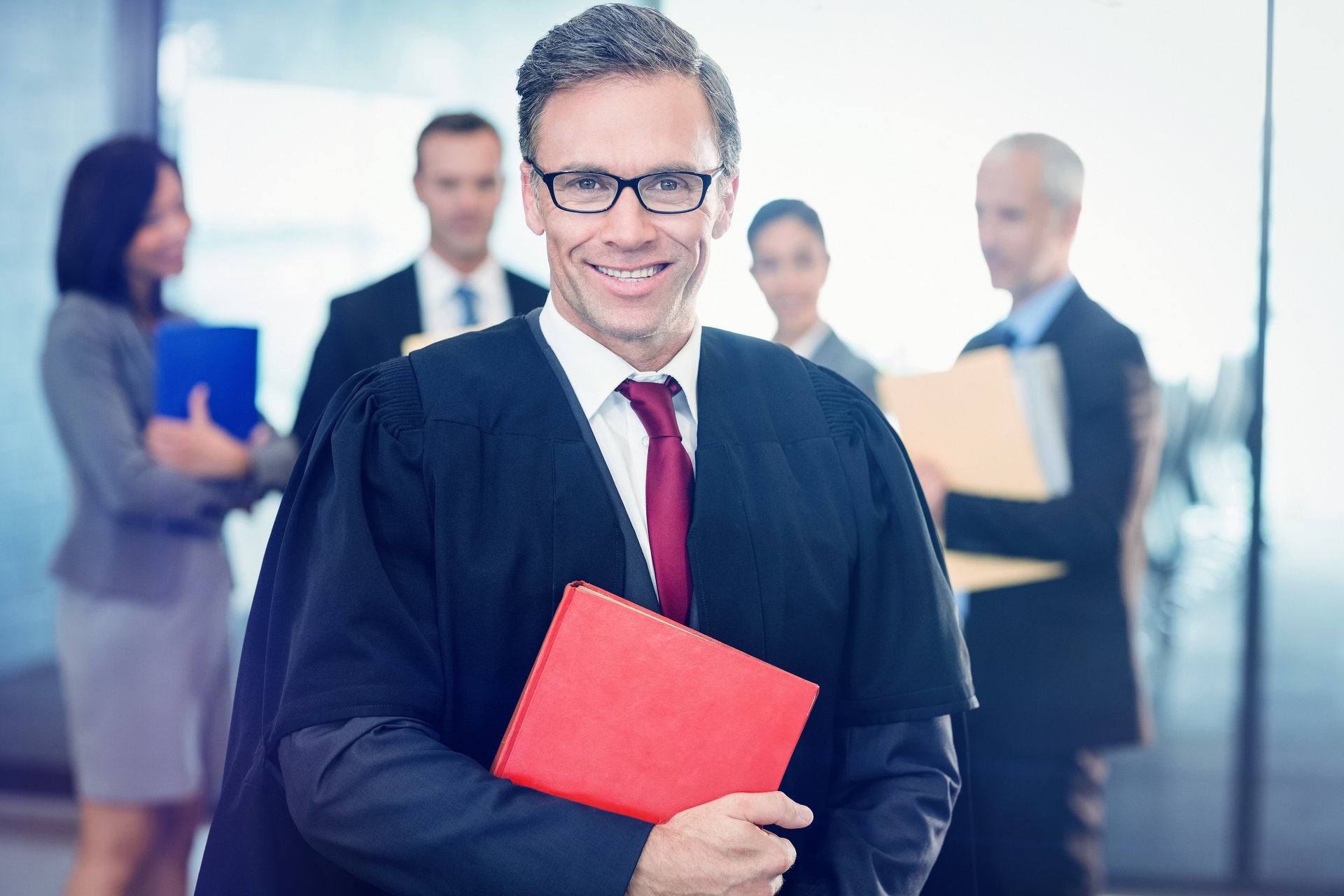 stockphotoportraitoflawyerholdinglawbookinoffice532113529